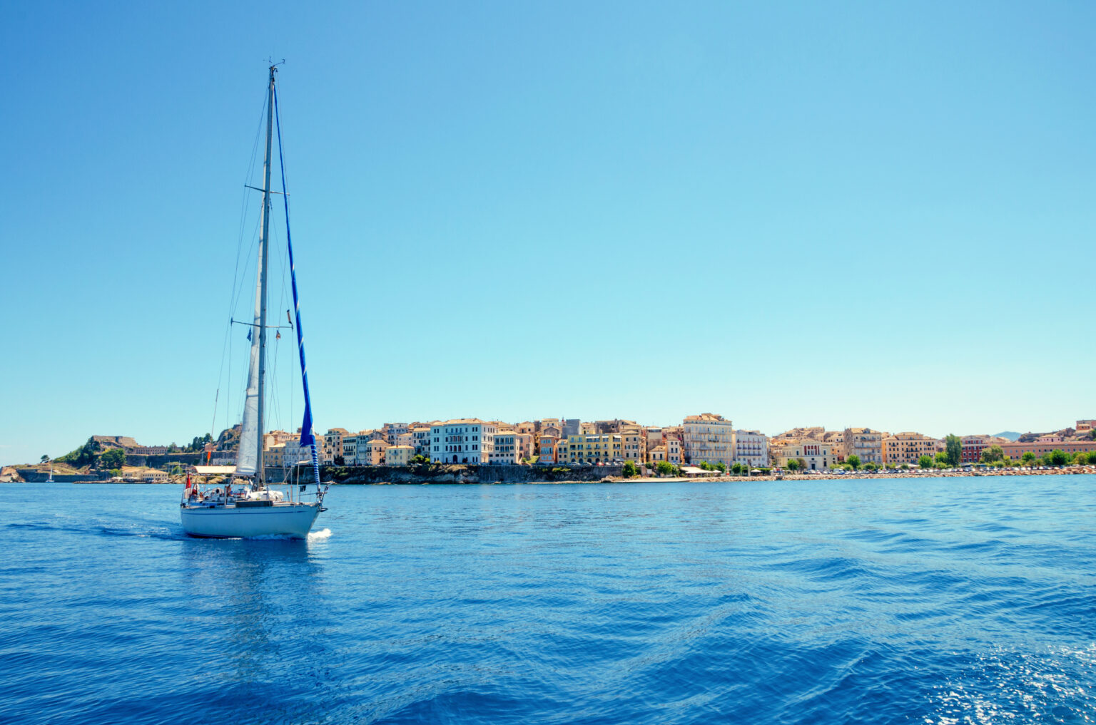sailboat off the coast of the island of corfu in greece