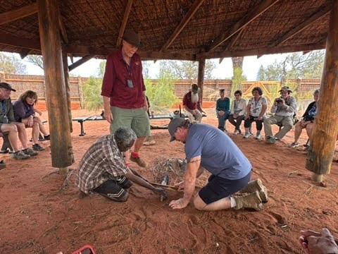 Odysseys guests work with local Anangu people during a cultural experience in the Outback